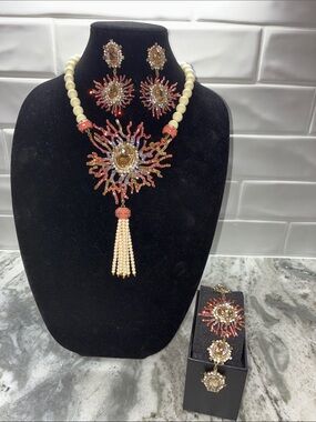 Three piece necklace, earrings, and bracelet set by Heidi Daus.